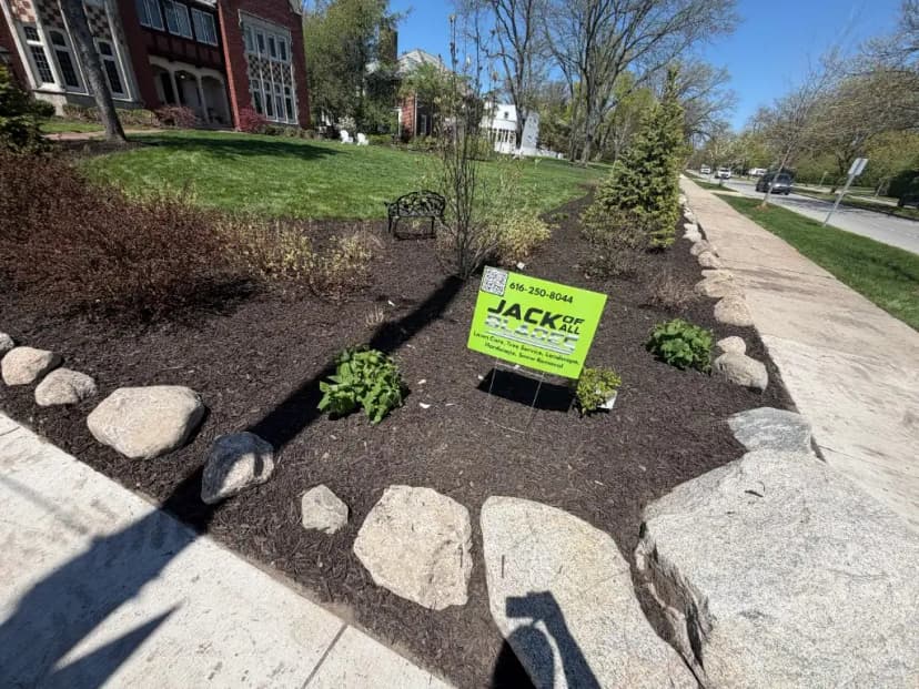 Front yard landscape design with mulch and boulders Grand Rapids MI