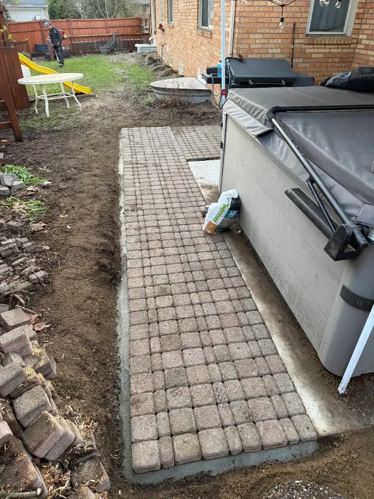 Completed paver pad alongside hot tub Grand Rapids MI